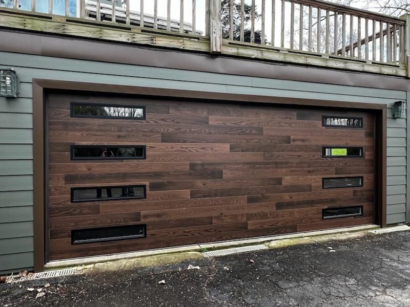 The garage door is made of wood and has a lot of windows.