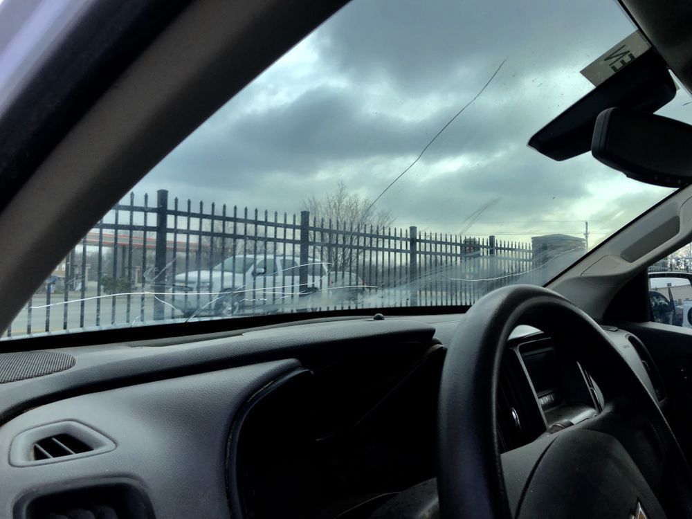 The inside of a car with a steering wheel and dashboard