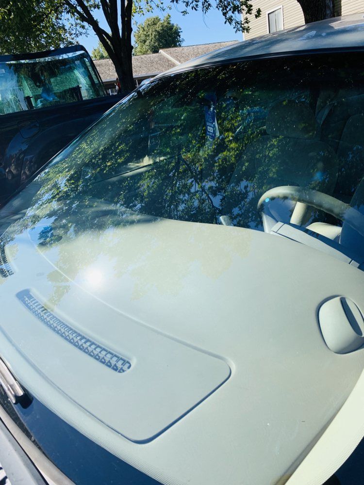 A close up of a car windshield and dashboard