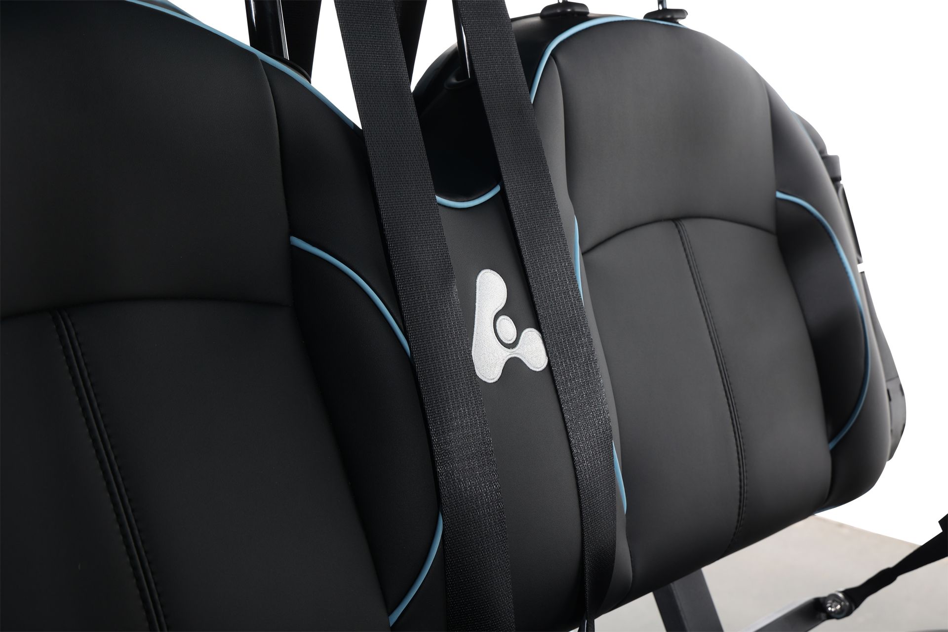 A black bag is hanging from the back seat of a golf cart.