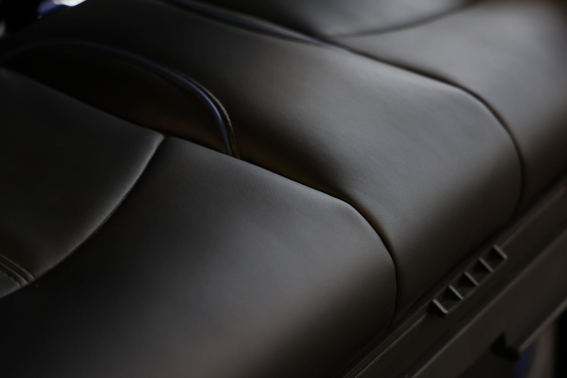 A close up of a leather seat in a car