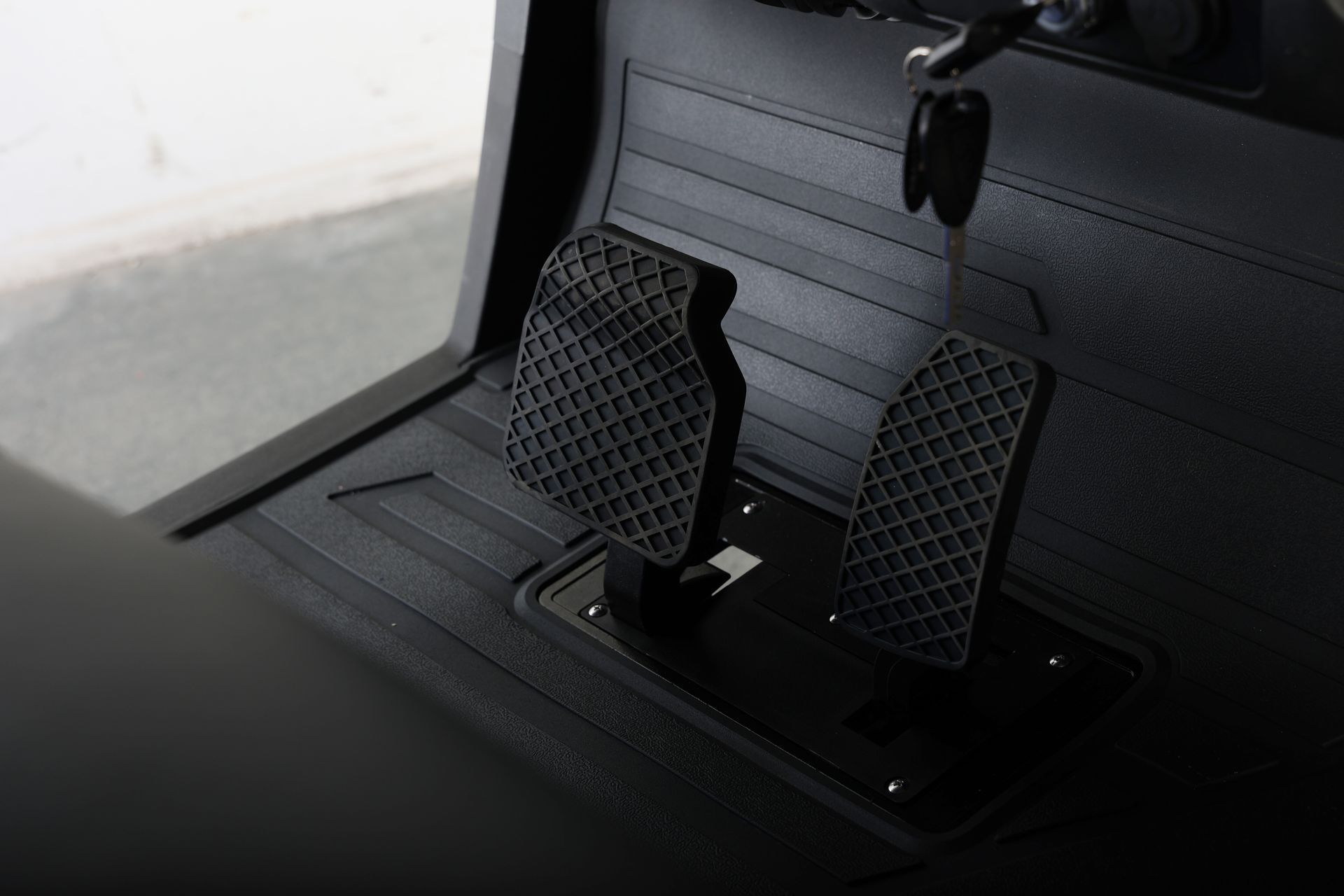 A close up of a brake pedal in a car.