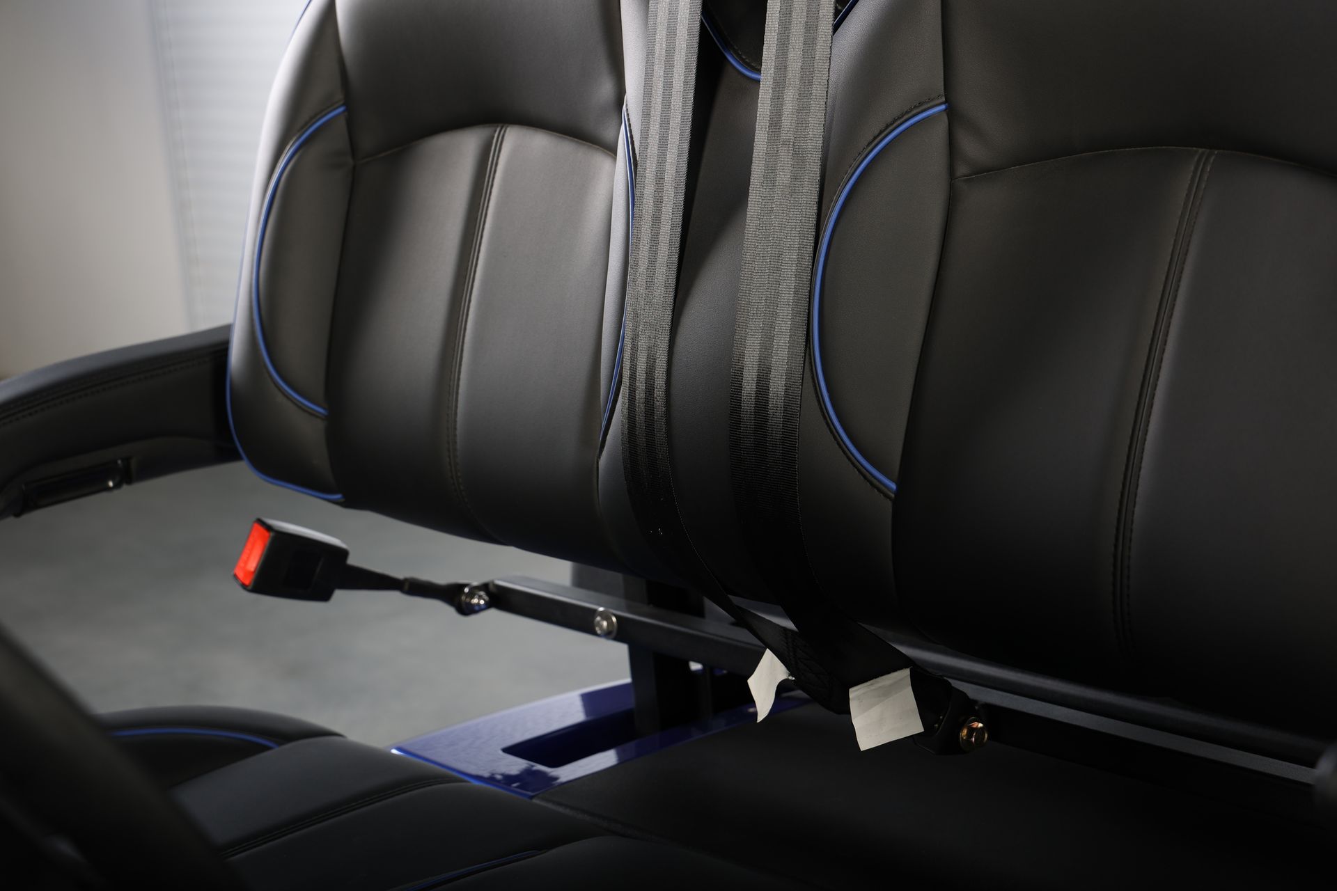 A close up of a seat with a seat belt on it.