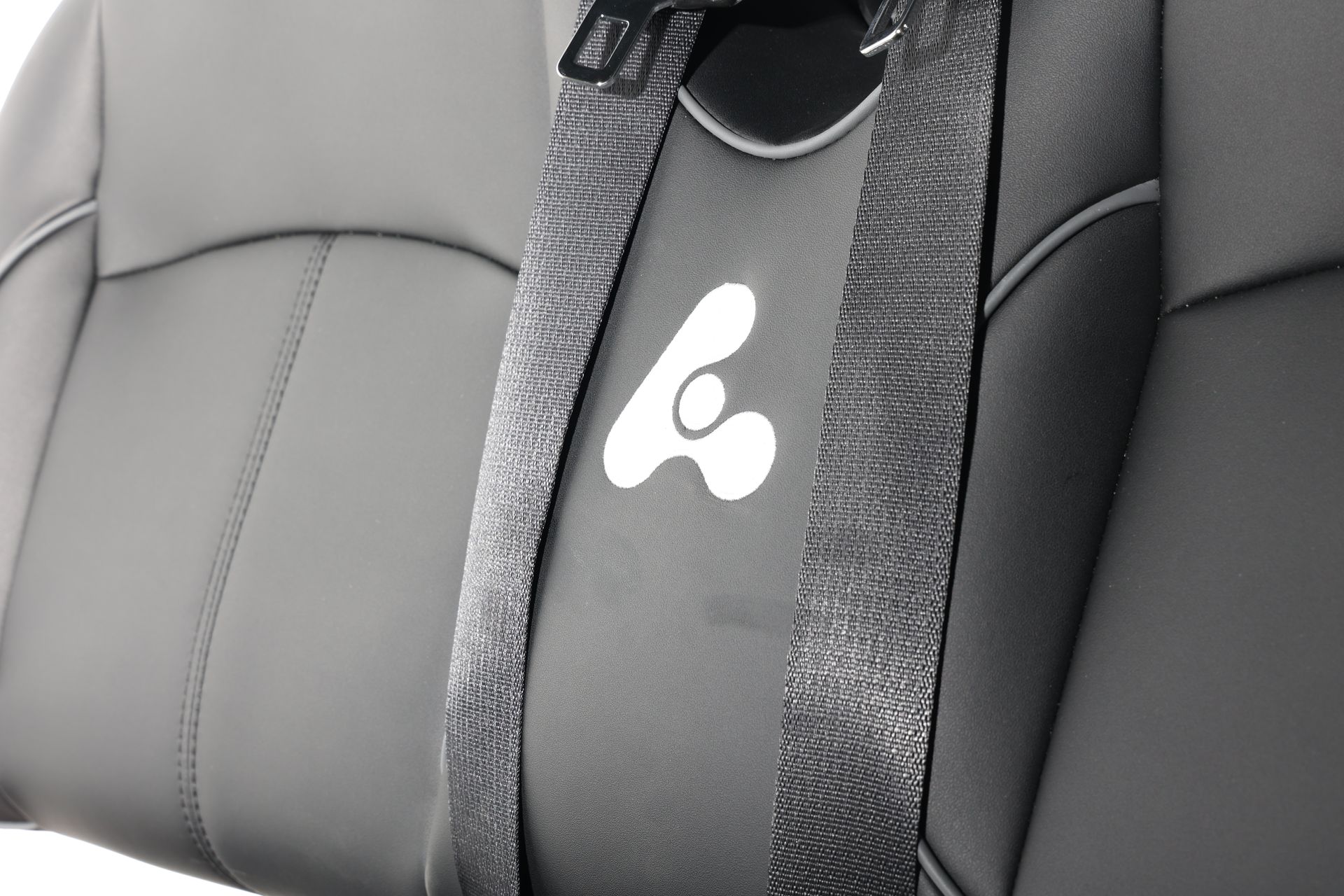 A close up of a car seat with the letter a on it