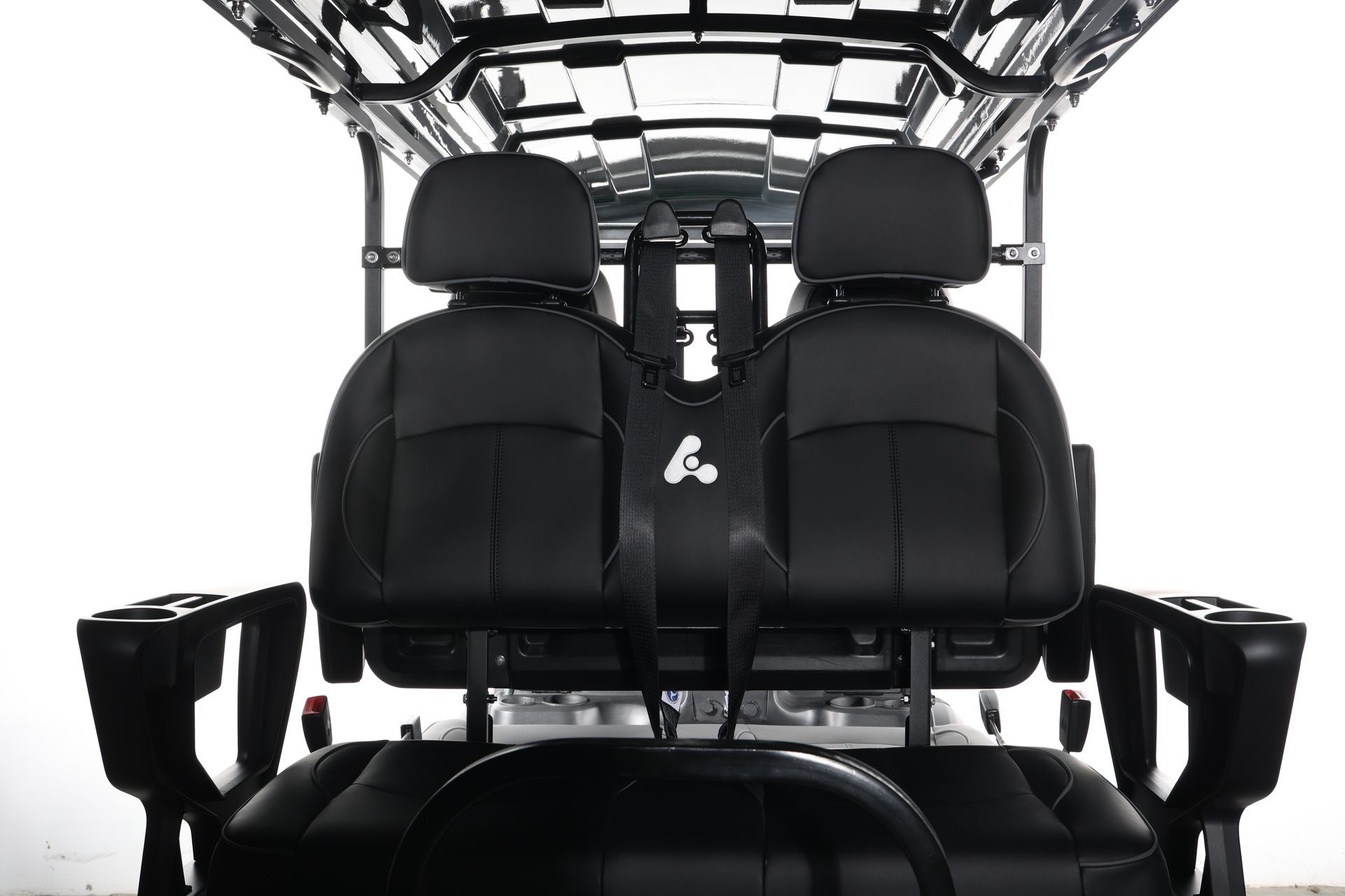 The back of a golf cart with black seats and a steering wheel.