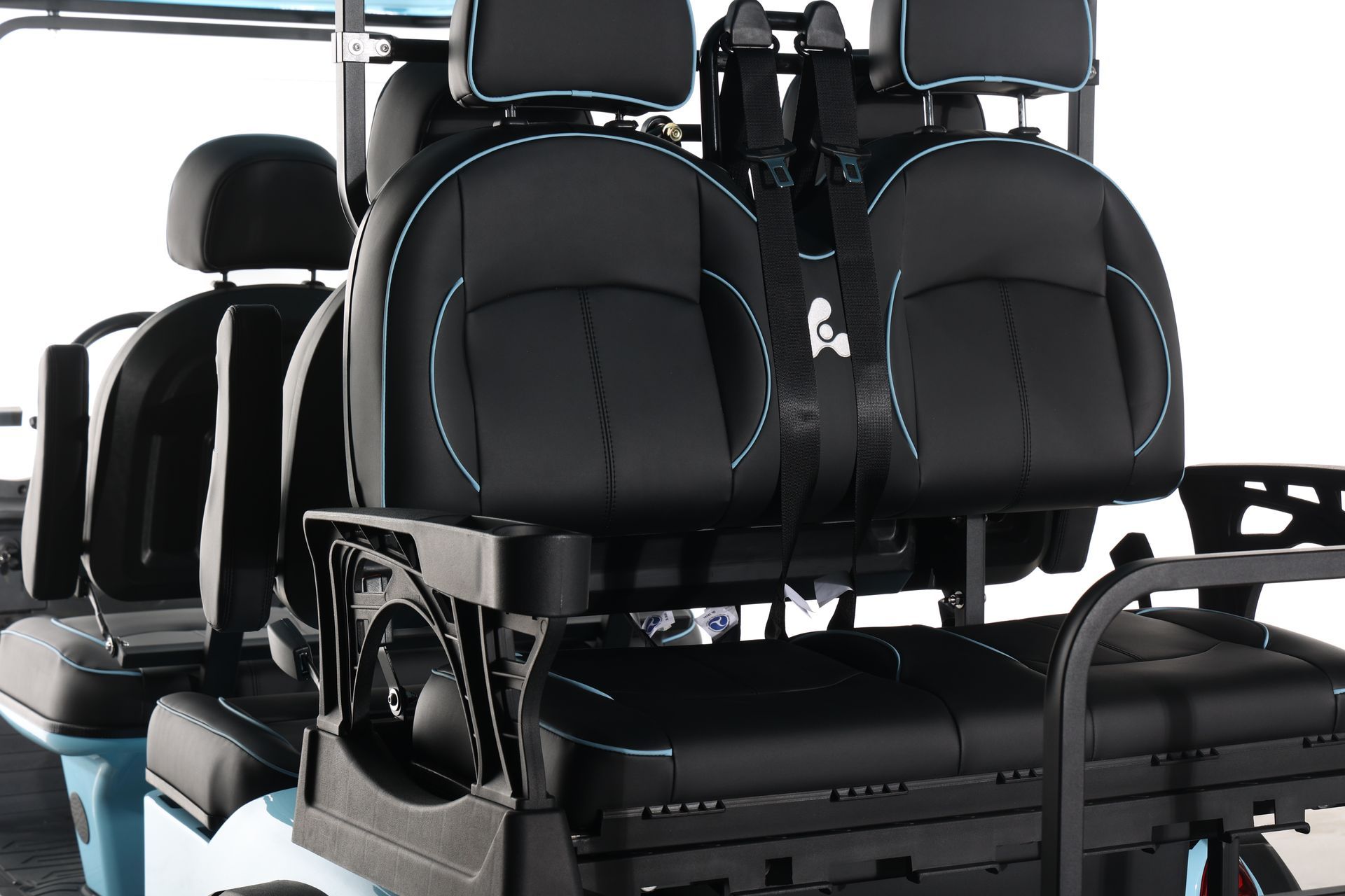 The back seat of a golf cart with black seats and blue trim.