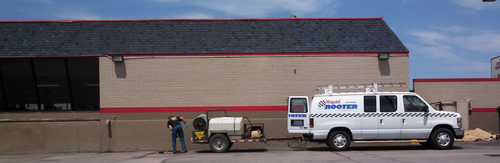 A white van is parked in front of a building
