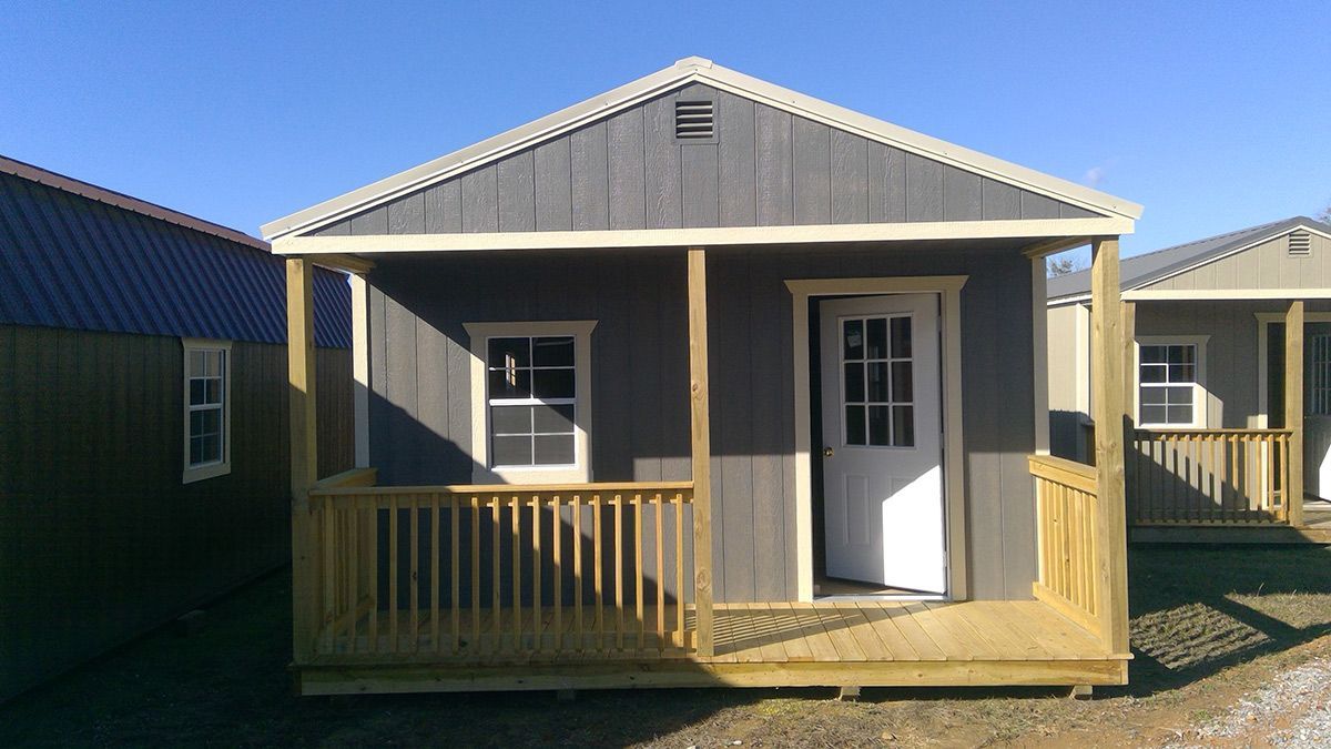 A small house with a porch and a door