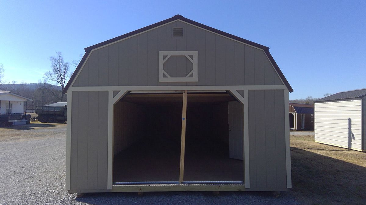 An empty barn with a square on the side of it