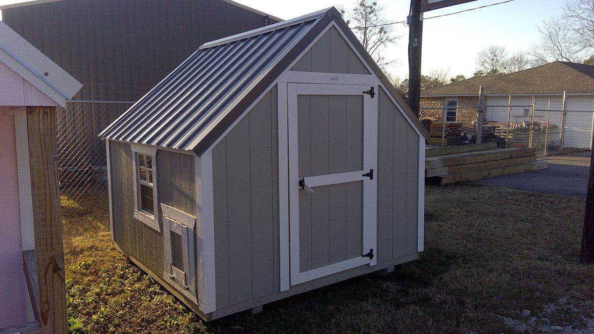 A small shed with a metal roof and a window