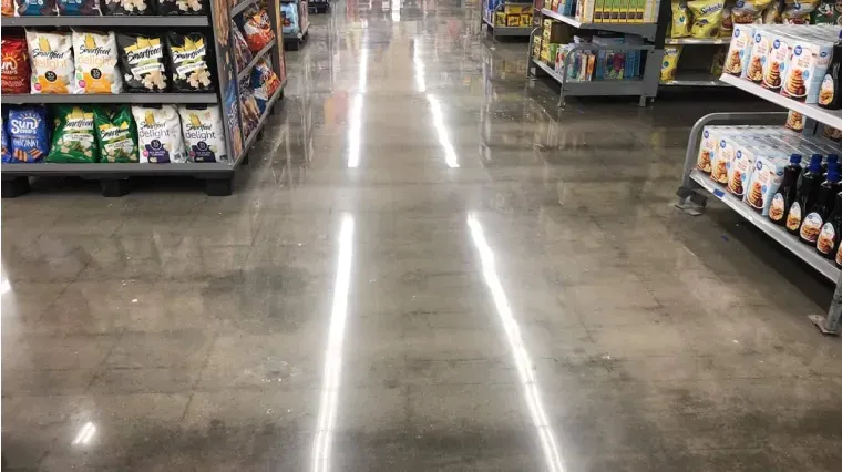 Grocery store aisle with polished floor and snack shelves on both sides