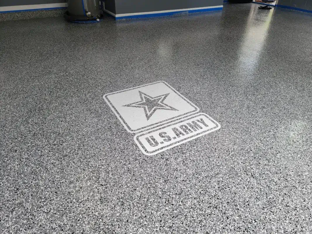 Speckled gray floor with a U.S. Army star emblem and logo tile in the center.