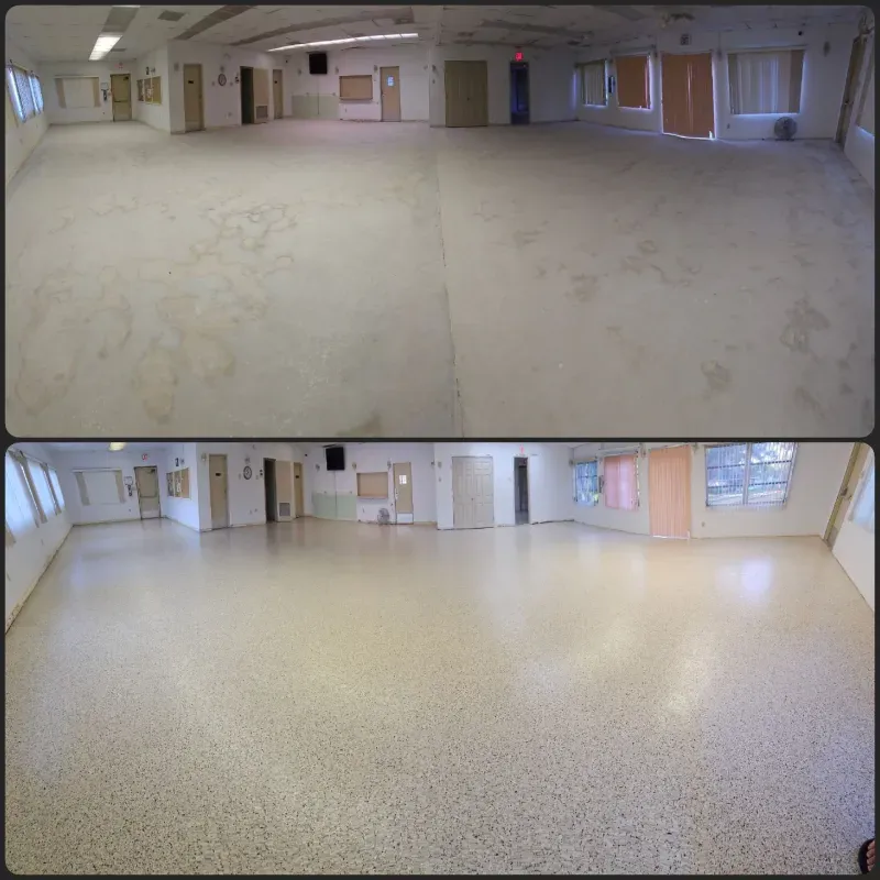 Empty indoor room with beige walls, windows, and two wide views of the floor and ceiling.