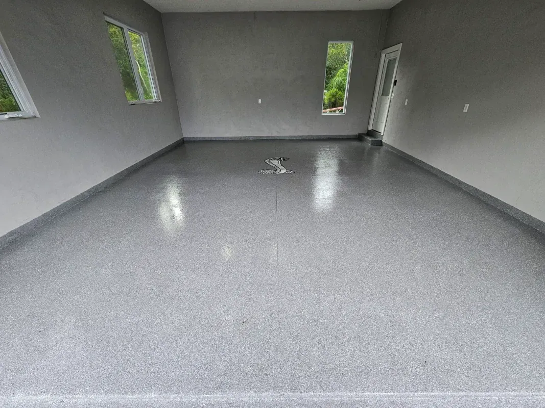 Empty gray room with polished floor and small windows on three walls