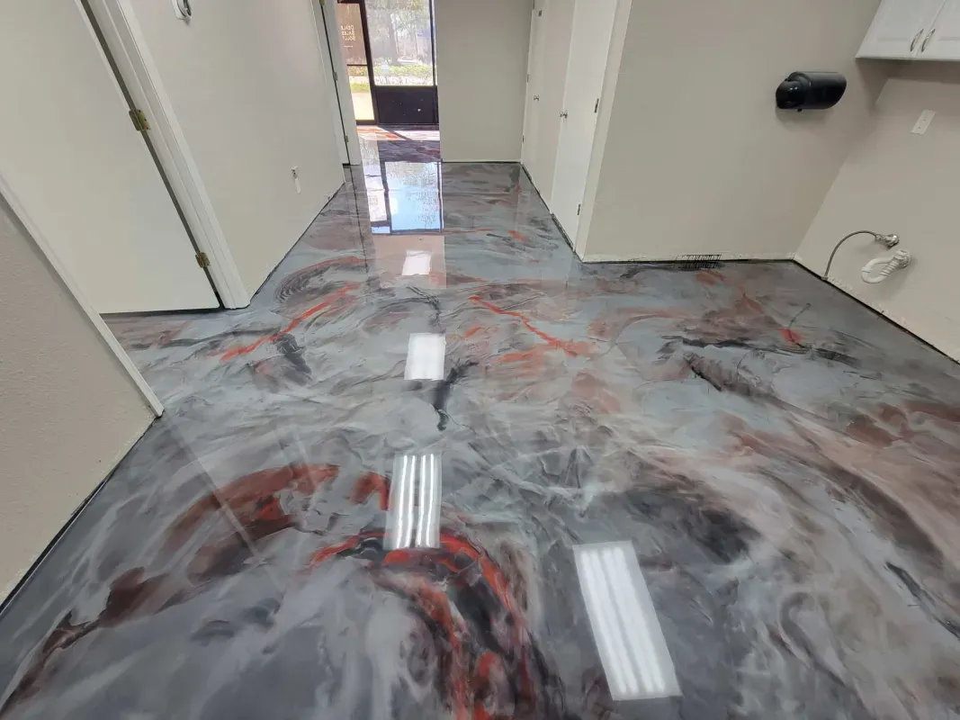 Marbled epoxy floor in a hallway with white walls and fluorescent light reflections