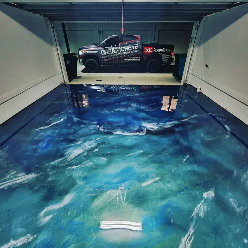 Blue wave-patterned trailer floor with a black race truck parked at the back.