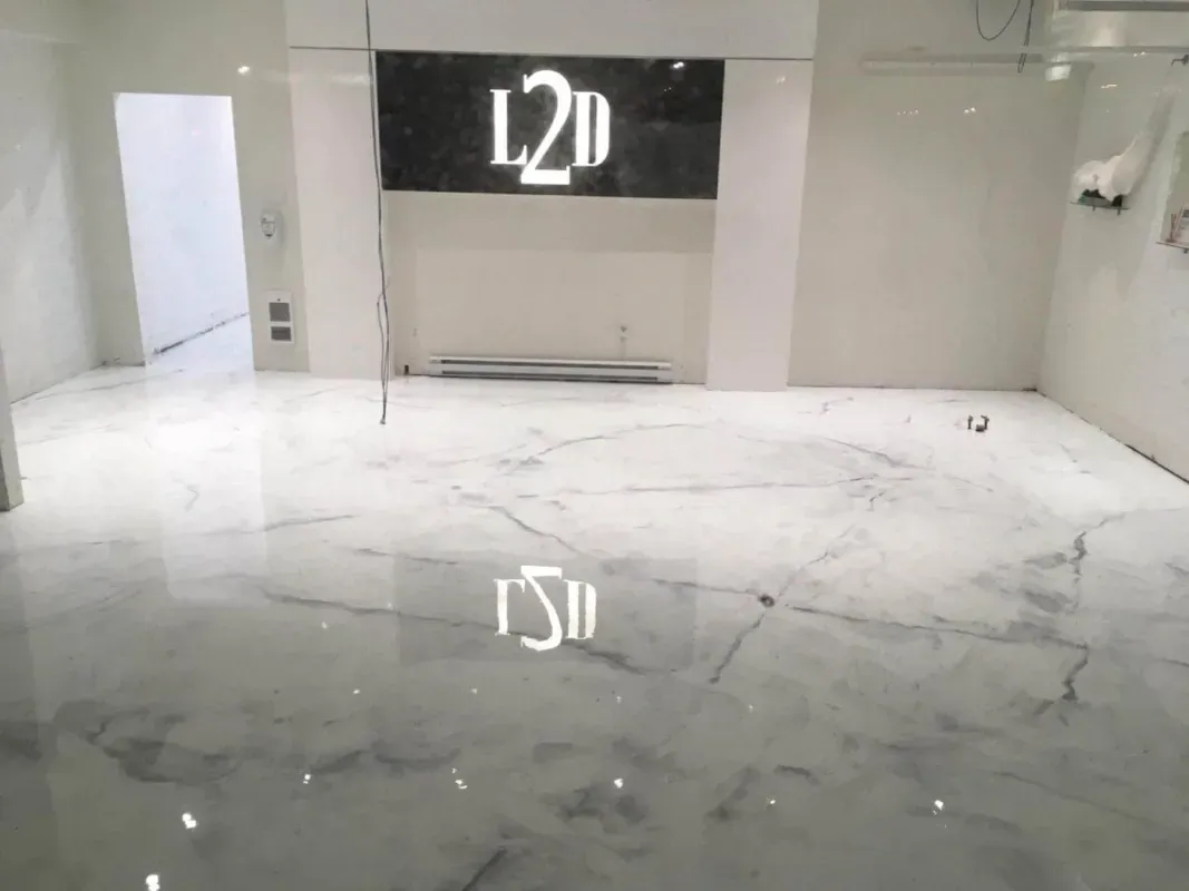 Empty modern lobby with glossy white marble floor and black L2D sign on the wall