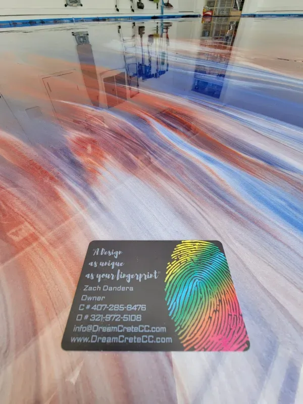 Blurred multicolor streaks with a small black business card in the foreground on a glossy floor