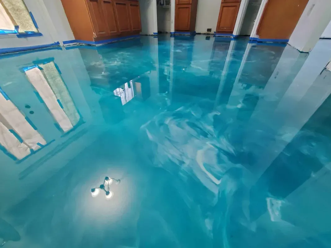 Indoor pool with bright blue water, white columns, and wooden doors reflected on the surface