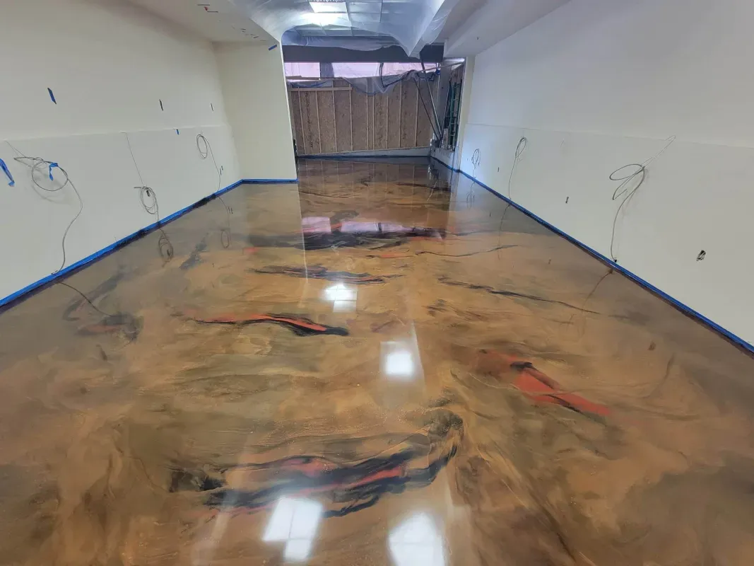 Flooded hallway with muddy water and debris, leading to a wooden barrier at the far end.