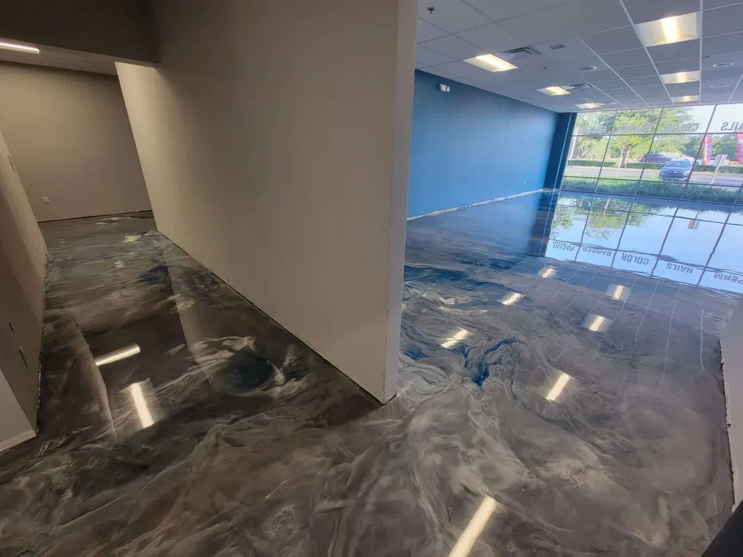 Empty office lobby with glossy gray marble floor and large windows overlooking water