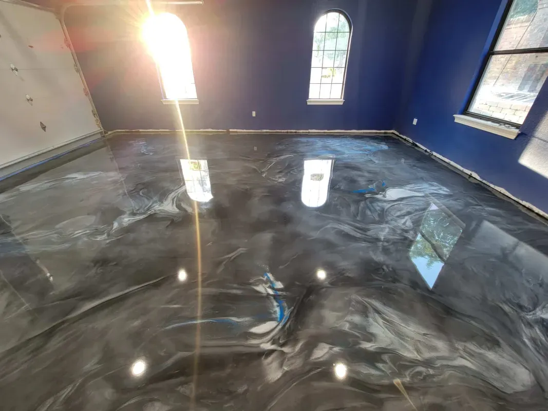 Freshly coated glossy floor in a blue room with windows and a bucket near the center