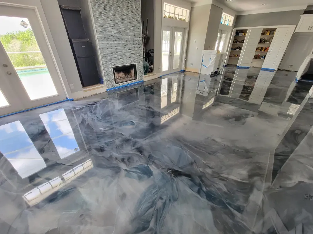 Modern living room with glossy gray marbled floor, large windows, and a fireplace.