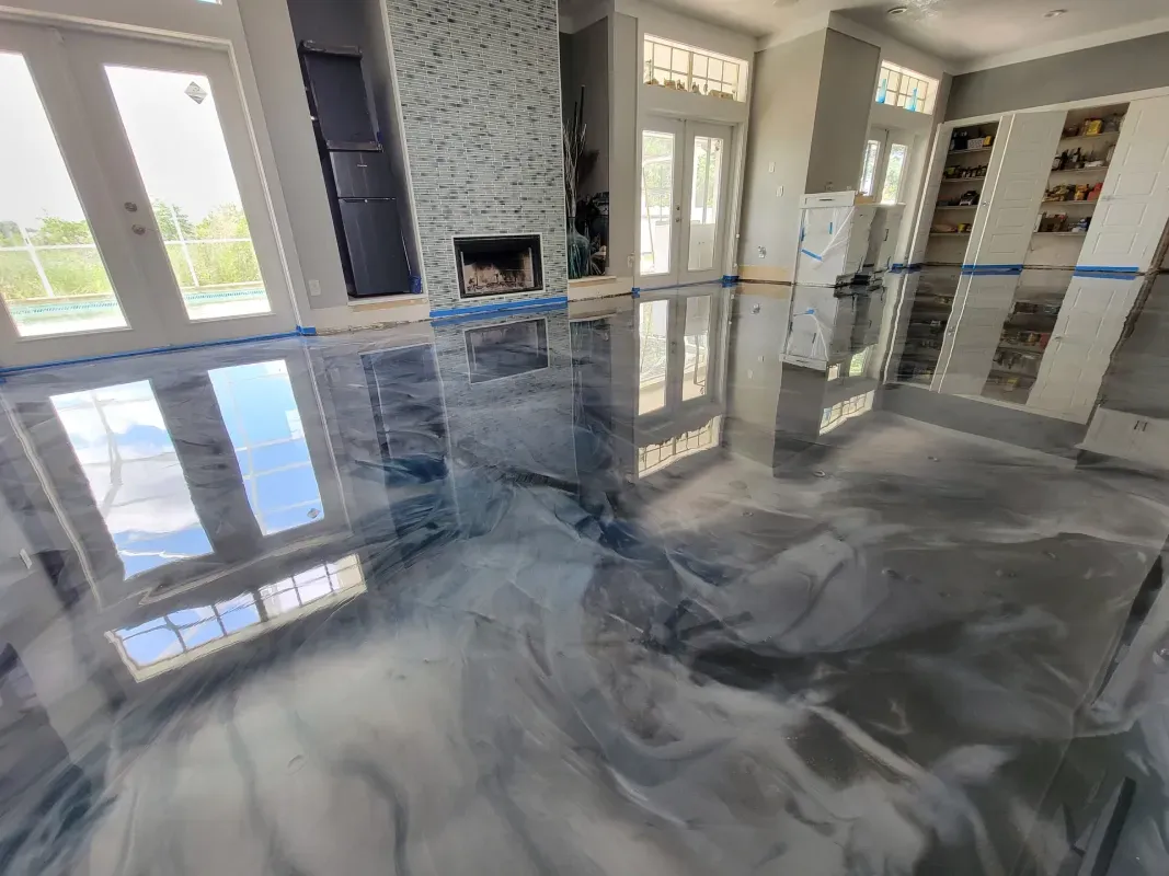 Luxury kitchen with glossy gray marble floors, large windows, and a white stone fireplace
