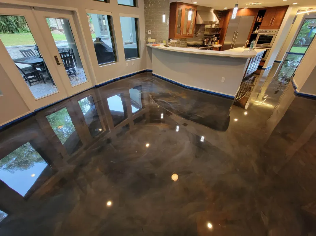 Empty glossy tiled room with large windows and a curved white bar counter.