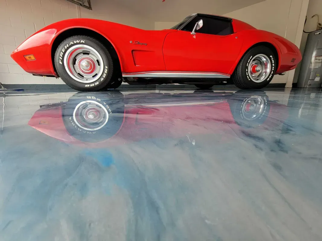 Red vintage sports car with a glossy reflection on a polished floor