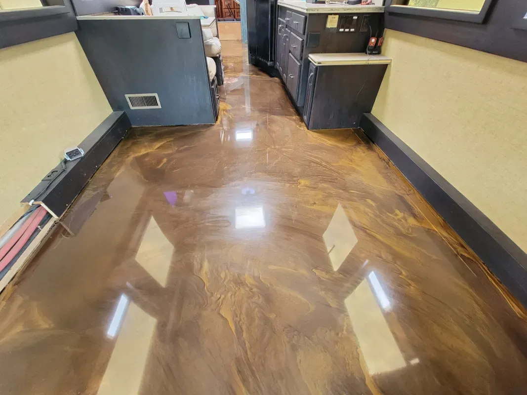 Shiny brown polished hallway floor with windows reflecting light and cabinets along both sides