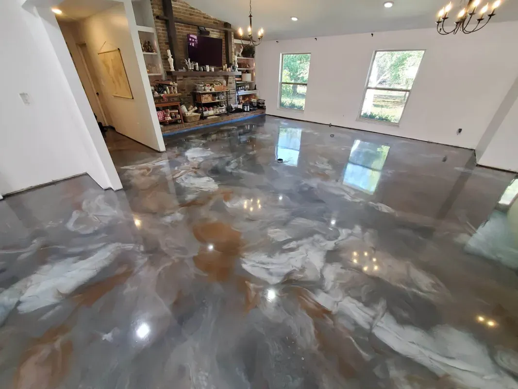 Shiny metallic epoxy floor in a modern empty room with windows and open kitchen area