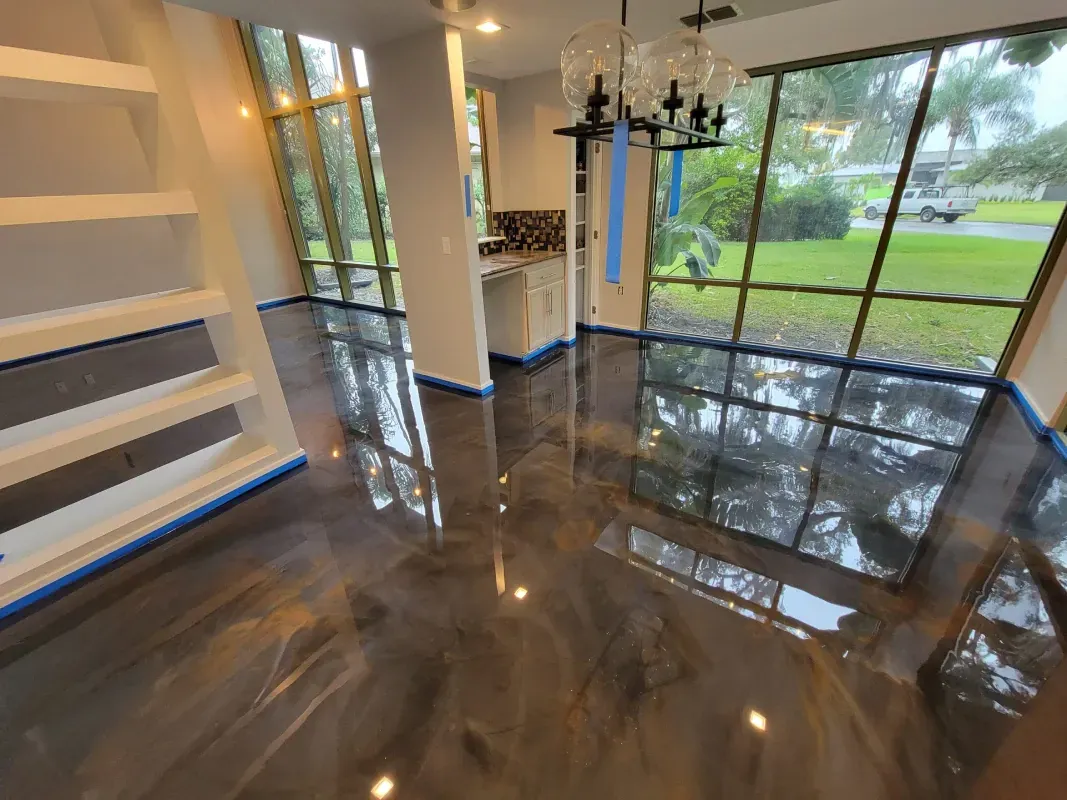 Empty modern interior with glossy dark floor, white shelves, and large windows overlooking greenery