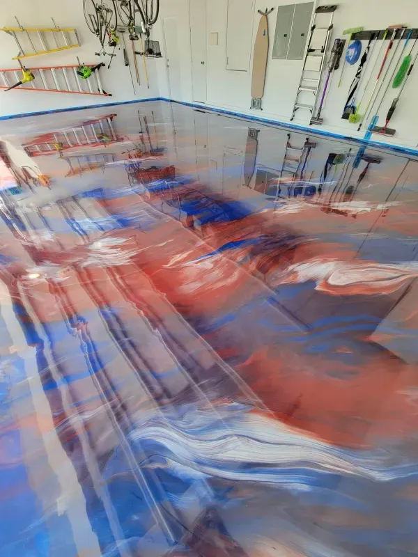 Blurred red and blue sailboat in a workshop with hanging tools and equipment on the wall
