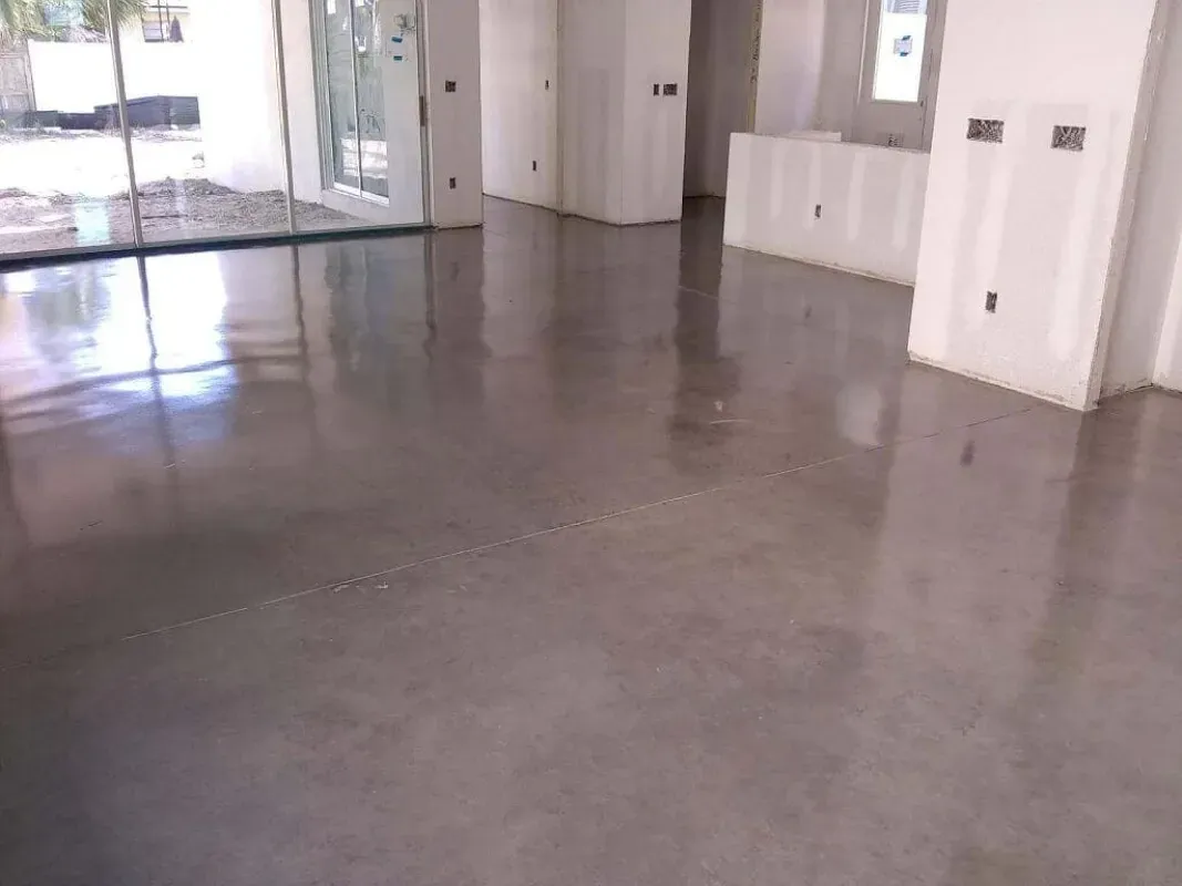 Empty office lobby with polished concrete floors and glass doors.