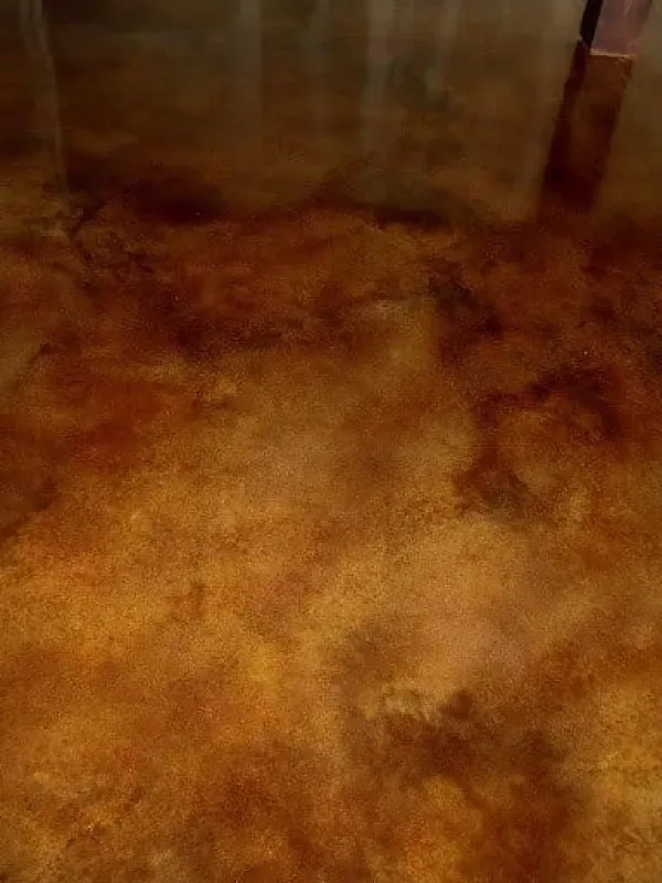 Brown carpeted floor with a mottled orange and tan pattern, viewed close up
