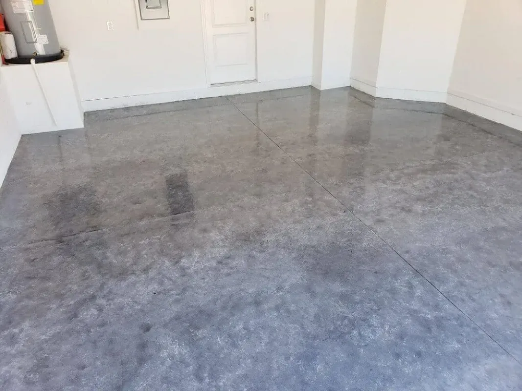 Empty room with a gray concrete floor and white walls