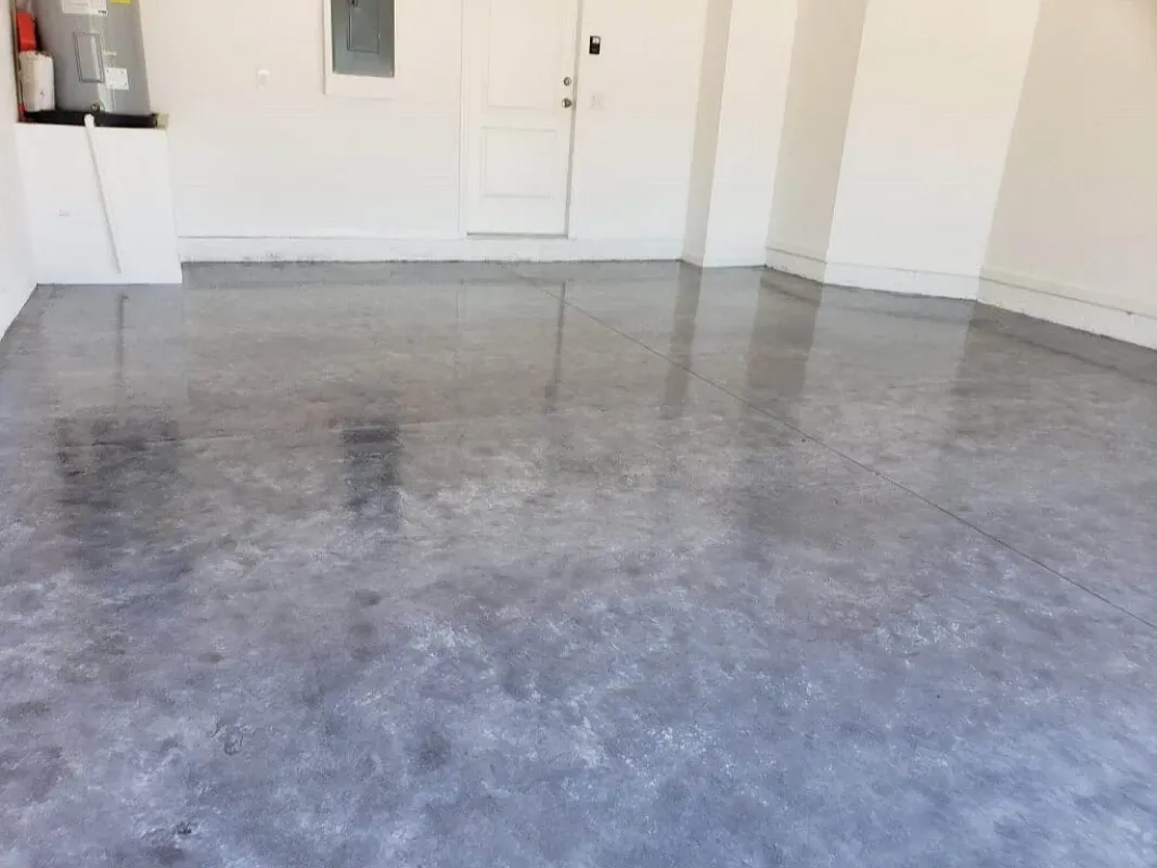 Empty room with a polished gray concrete floor and white walls