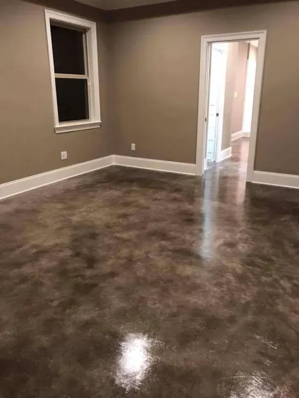 Empty room with glossy brown floor, beige walls, a window, and an open doorway.