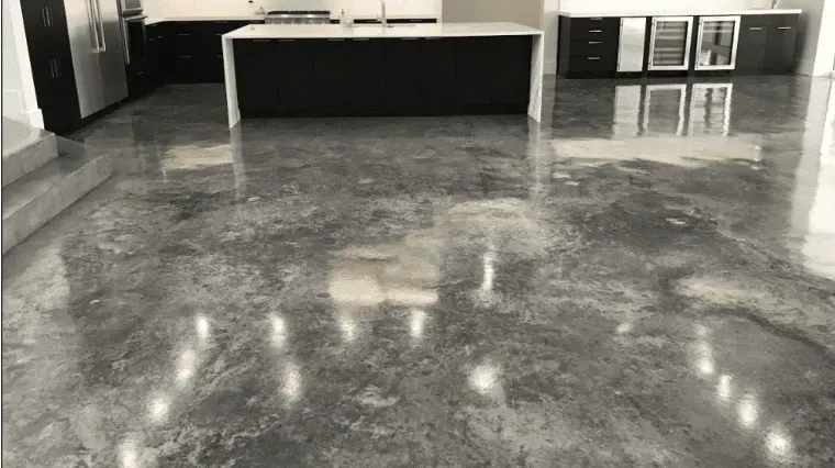 Empty glossy showroom floor reflecting overhead lights and display counters along the back wall