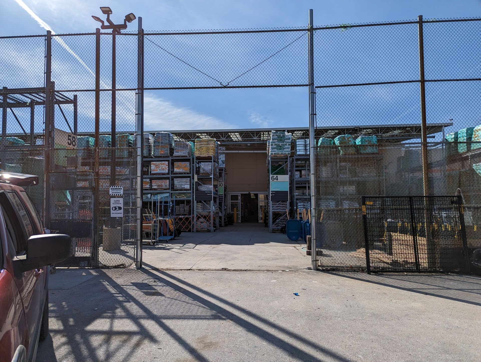 A truck is parked in front of a chain link fence.