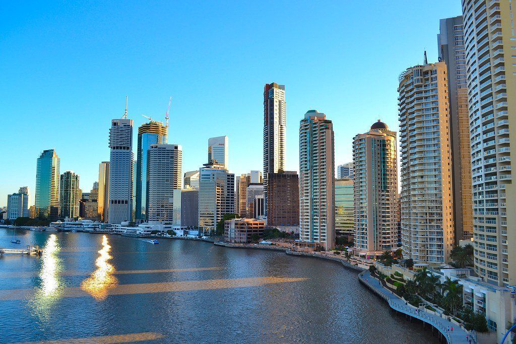 Brisbane, Australia skyline with skyscrapers on a sunny day reflected in the Brisbane River.