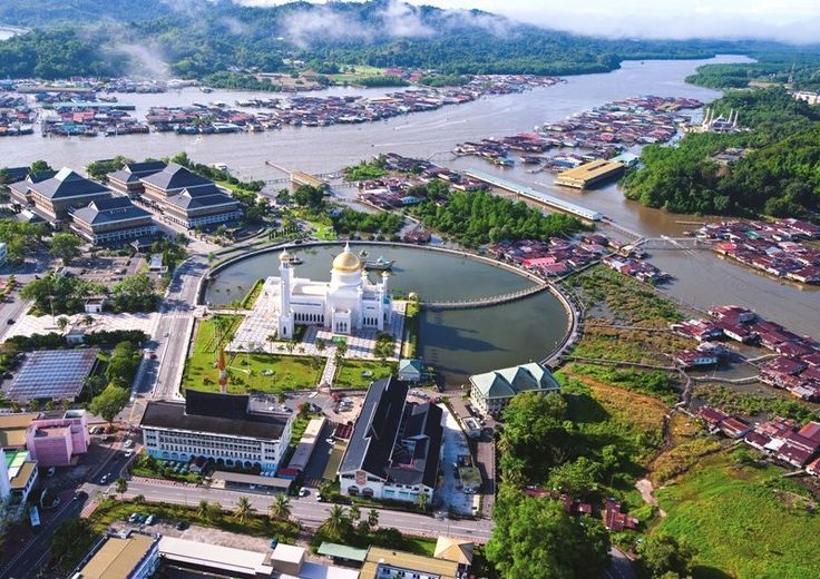 Aerial view of Bandar Seri Begawan, Brunei, with a white mosque and river houses.