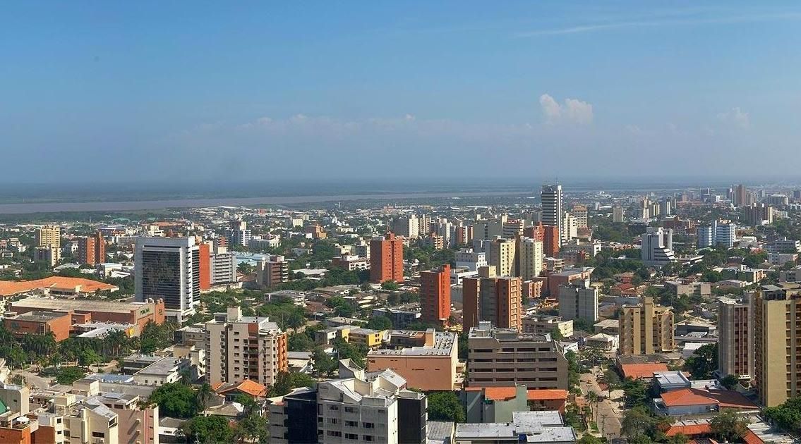 Cityscape with many buildings under a clear blue sky.  The buildings range in height and are clustered together.