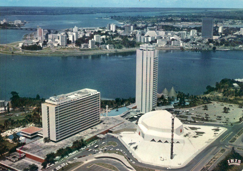 Aerial view of Lagos, Nigeria, with tall white buildings, a water body, and cityscape in the background.