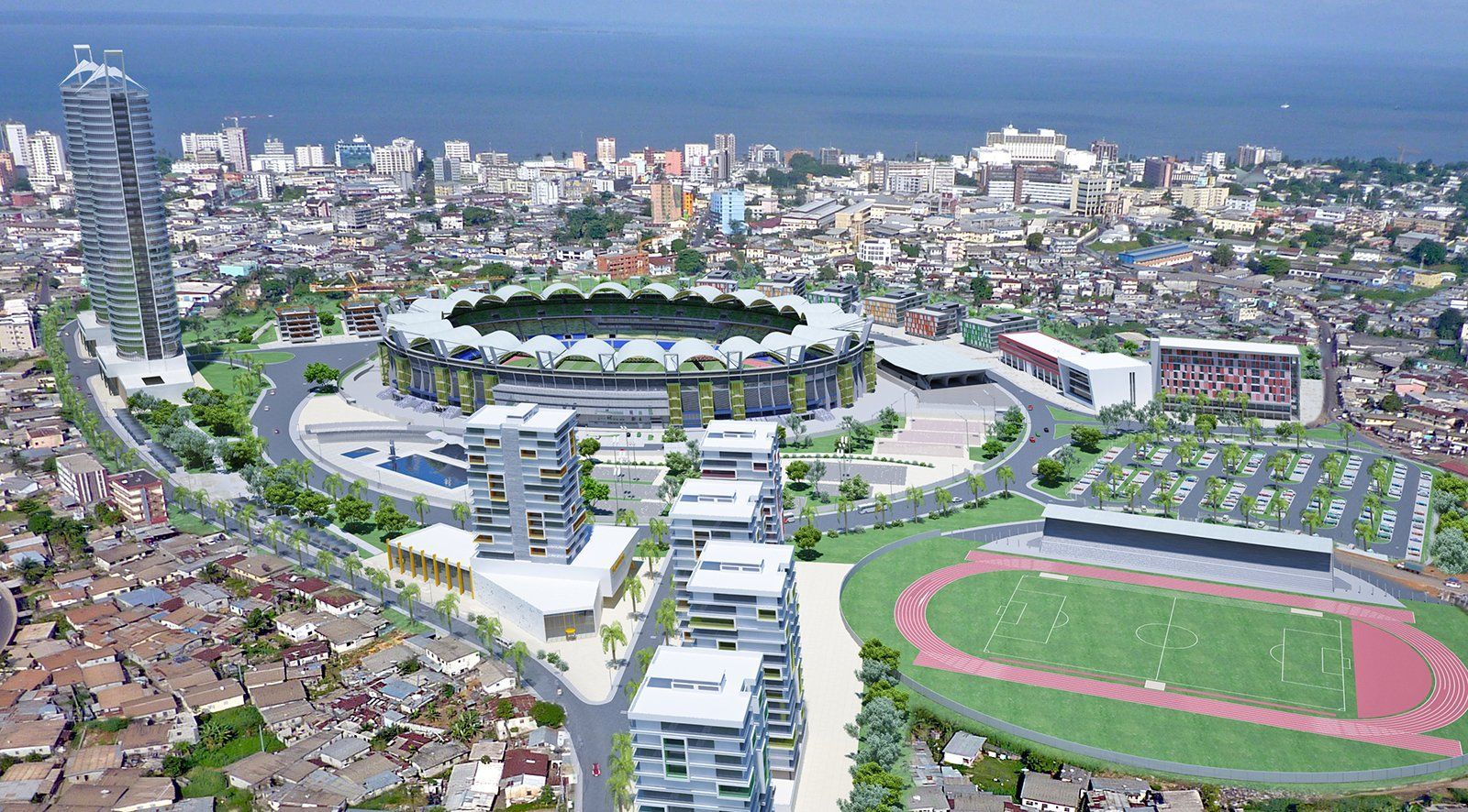 Aerial view of a modern sports complex in a densely populated city. It features a stadium, track, parking, and high-rise buildings.