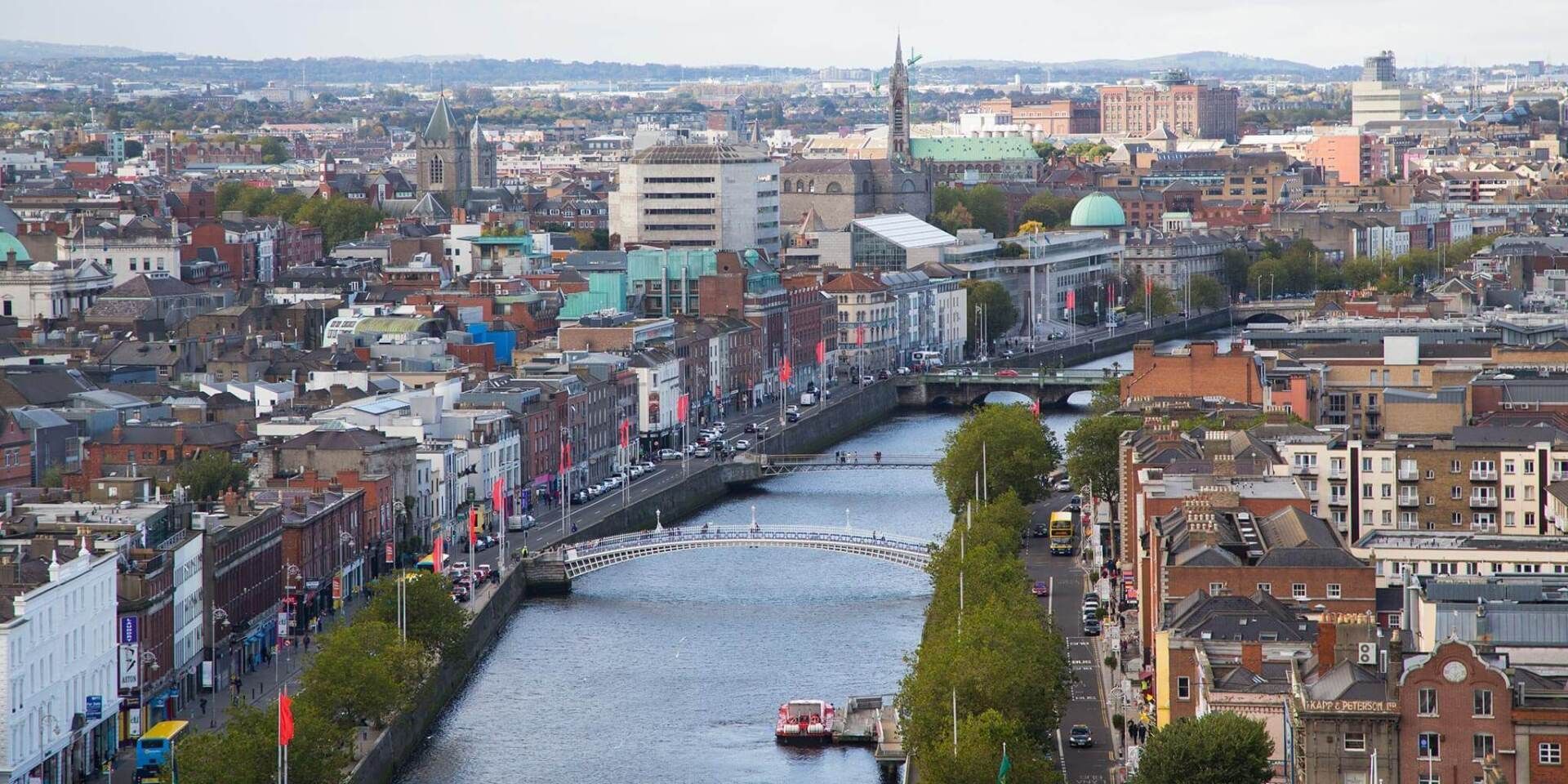 View of Dublin city center with a river running through, surrounded by buildings.