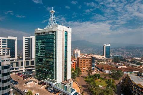 High-angle view of buildings in Kigali, Rwanda, on a sunny day. The central building is a tall office tower with a communications tower on top.