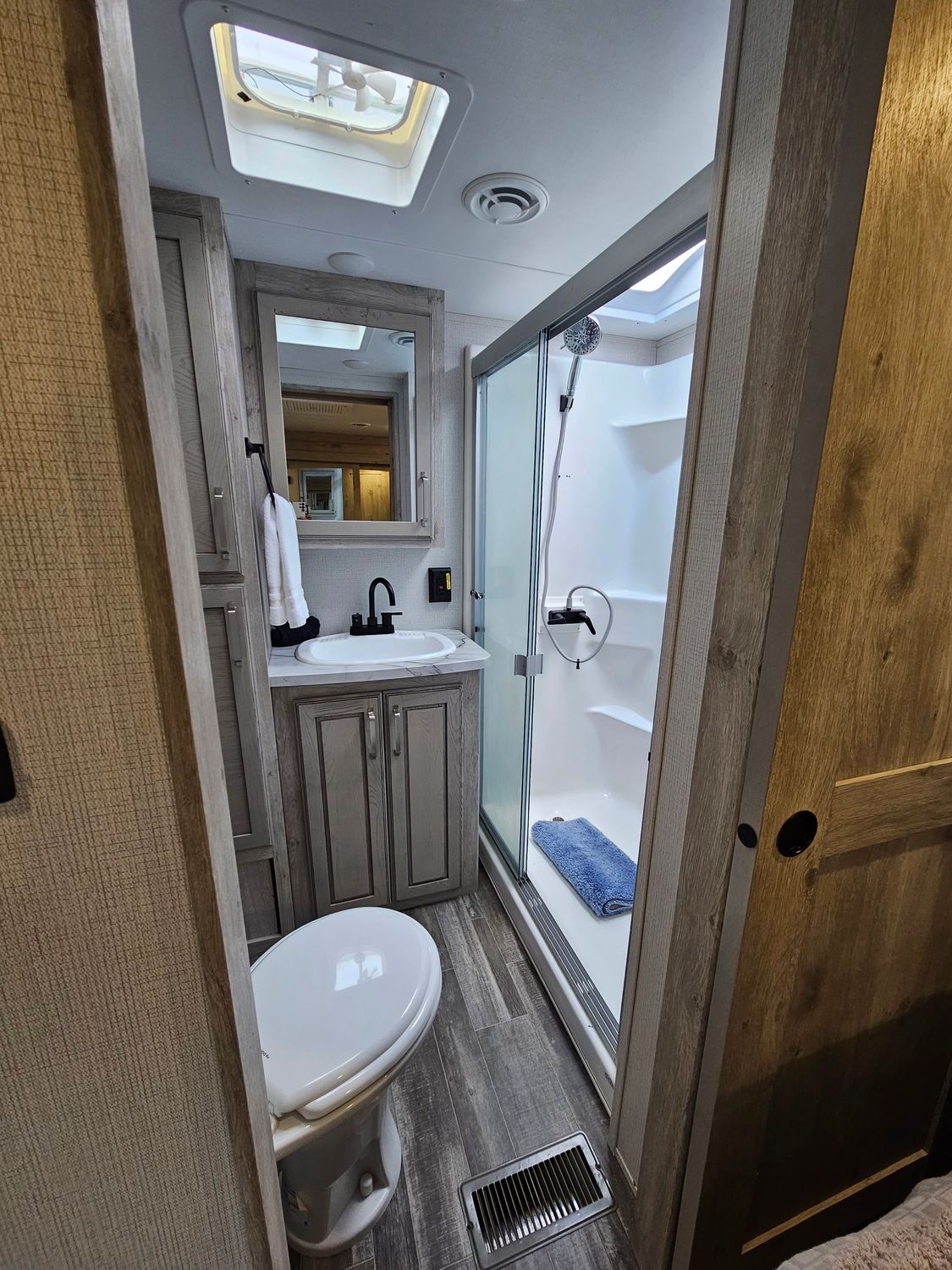RV bathroom: toilet, sink, shower.