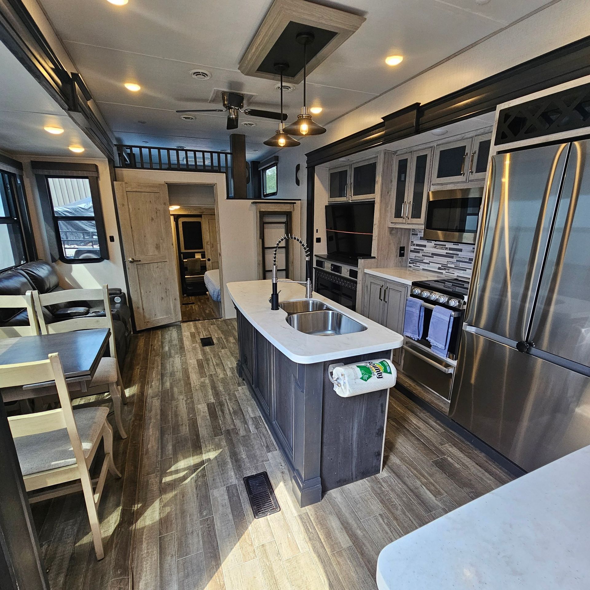 A kitchen with stainless steel appliances and a large island